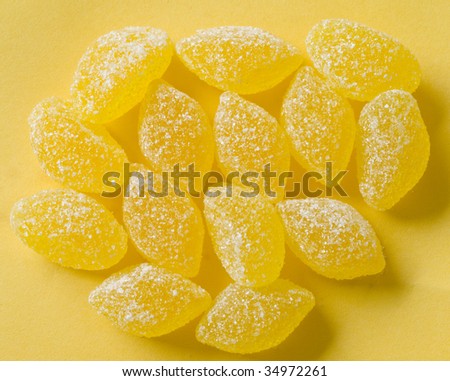 yellow candies with white sugar on yellow background with yellow shadows