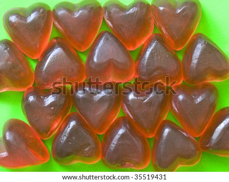sweet and soft rubber hearts on green background