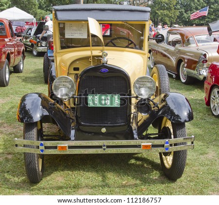 WAUPACA, WI - AUGUST 25: Front view of 1929 yellow Ford Model A car at the 10th Annual Waupaca Rod & Classic Car Club Car Show on August 25, 2012 in Waupaca, Wisconsin.