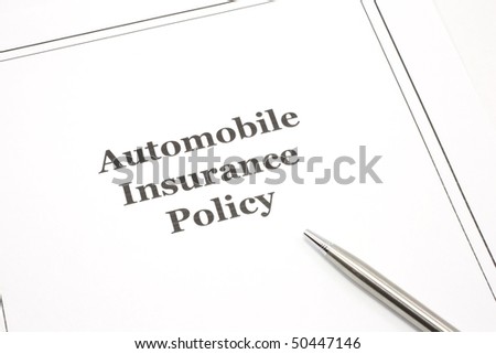 An automobile insurance policy with a pen ready to be signed.