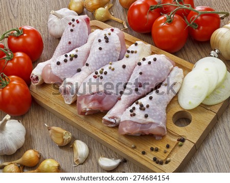 chicken drumstick with vegetables on wooden table