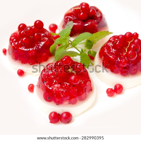 Cakes with jelly and currant and mint on a white background