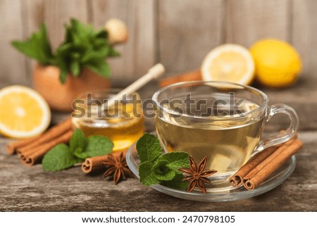 Similar – Image, Stock Photo Glass cup with ginger and lemon tea, on a yellow background along with its ingredients.