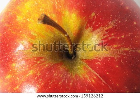 One Juicy Hot Red Apple over a White Background