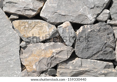 Texture Gray Rock Ancient Wall made of Volcanic Rocks