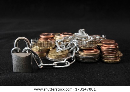 Secure Savings - Lock and Some Coins on a Black Background
