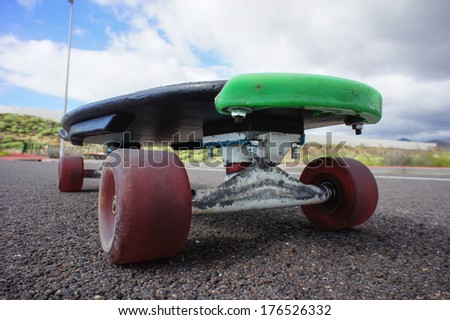 Vintage Style Longboard Black Skateboard on an Empty Asphalt Desert Road