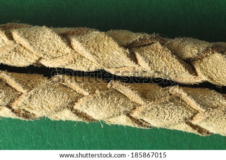Brown Textured Braided Leather Necklace on a Colored Background