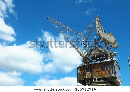 Old Vintage Wooden Port Crane on a Blue Sky