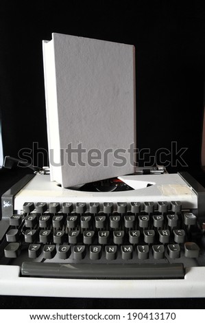 An Old Travel Vintage Typewriter on a Black Background