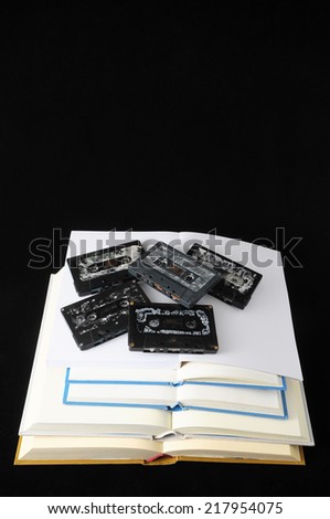 Empty Classic Book and Music Tape Isolated over a Black Background