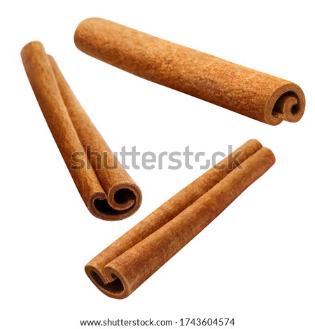 Flying delicious cinnamon sticks, isolated on white background