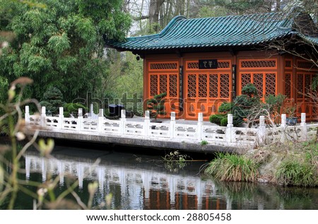 Japanese Tea House. Tea-House is located at a nice river with chinese traditional dragon roof and nice white fence. The railing is a nice contrast to the wood and bamboos.