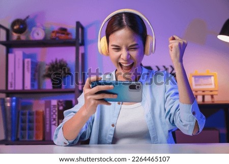 Similar – Image, Stock Photo Cheerful woman in headphones using smartphone at home