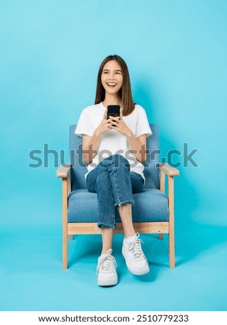 Similar – Image, Stock Photo young woman sitting with headphones on the balcony facing the backyard and planting flowers and herbs