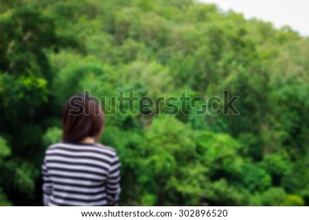 blurred photo of Woman standing posture with rounded nature ,vintage color tone.