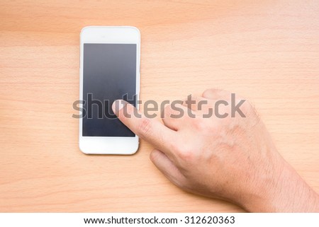Hand holding cellphone with blank screen on grunge background. You can put your design on the cellphone