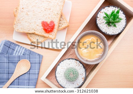 Bread with jam, strawberry tasty dishes on a wood floor. Ready to eat in the morning The appetizers are not hungry