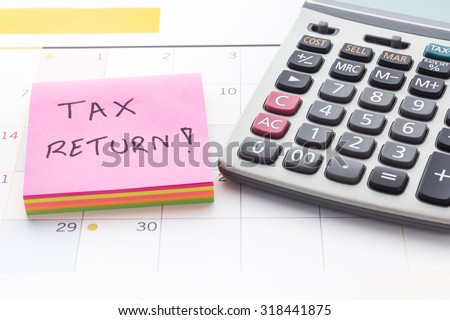 Calculator and Post-labeled concept, tax planning, tax return, with a calendar.