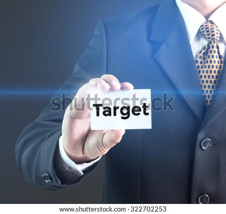 A Businessman holding a white sign with the message target. Can bring to the medium of your ad.