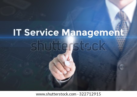 A Businessman holding a white sign with the message IT service management. Can bring to the medium of your ad.