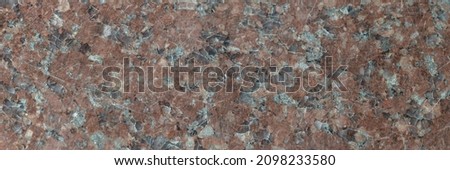 Red granite texture. A variegated, spotted background of red (brown) granite. The stone granite surface of brown-gray color. Surface view of granular igneous rock Photo stock © 