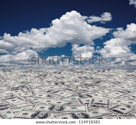 big pile of money. stack of american dollars on the sky backgrounds