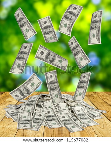 big pile of money. dollars over green background