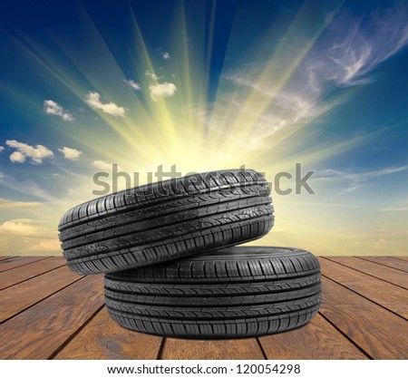 wheel rubber gift for Christmas on the wood textured backgrounds in a room interior