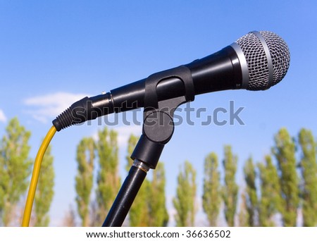 a black microphone on the sky backgrounds