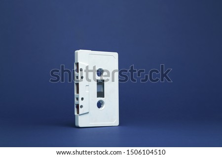 Audio cassette. Vintage white audio cassette tap on colored background. Composition of a  cassette tape audio isolated. Pattern of a audio cassette tap.