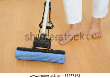 Mopping The Floor With A Sponge Mop