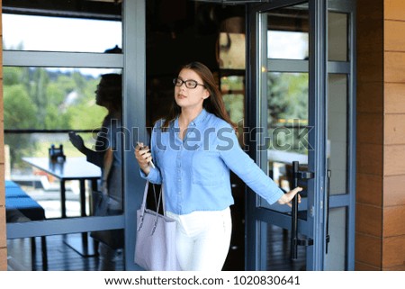 Similar – Image, Stock Photo Cheerful woman leaving restaurant