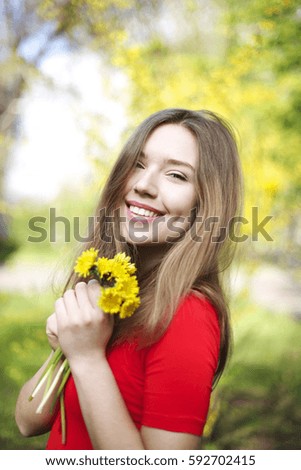 Similar – Image, Stock Photo Young dimpled woman smiles and looks at camera while standing in front of petrol blue wall