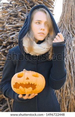 Woman with a pumpkin in the forest. Pumpkin lantern - decoration for Halloween.