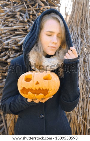 Woman with a pumpkin in the forest. Pumpkin lantern - decoration for Halloween.
