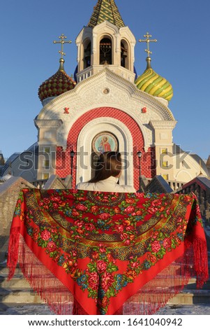 Look of russian tourist girl in vintage Pavlovo Posad shawl. Orthodox Saint Igor Chernigovsky's church in Novo-Peredelkino, Moscow, Russia. Russian traditional national folk and retro style in fashion