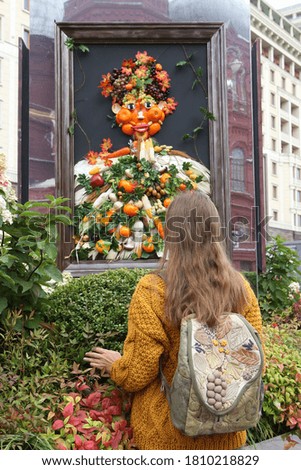 Tourist russian fashion woman with backpack. Outdoor celebration of Moscow’s City Day event on Manezhnaya Square near Red Square in Moscow city, Russia. Garden in city. Flower decor. Food art picture