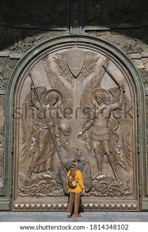 Door of Resurrection of Christ Cathedral, main cathedral of Russian Armed Forces. Patriot Park in Moscow city, Russia. Moscow architecture landmark. Church. Tourist woman with backpack. Street style
