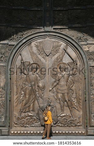 Door, gate of Resurrection of Christ CathedraI, main cathedral of Russian Armed Forces. Patriot Park in Moscow city, Russia. Moscow architecture landmark. Church. Tourist fashion girl with backpack