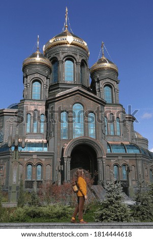 Resurrection of Christ Cathedral, main cathedral of Russian Armed Forces. Patriot Park in Moscow city, Russia. Moscow architecture landmark. Church. Tourist fashion girl with backpack. Street style