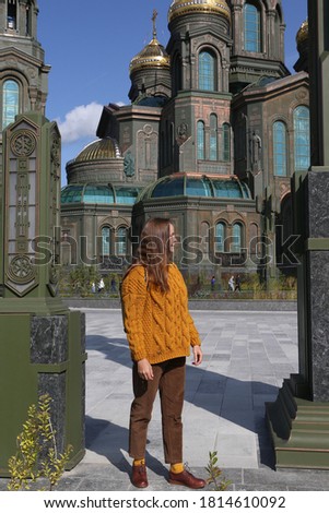 Resurrection of Christ CathedraI, main cathedral of Russian Armed Forces. Patriot Park in Moscow city, Russia. Moscow architecture landmark. Church. Tourist fashion girl with backpack. Street style