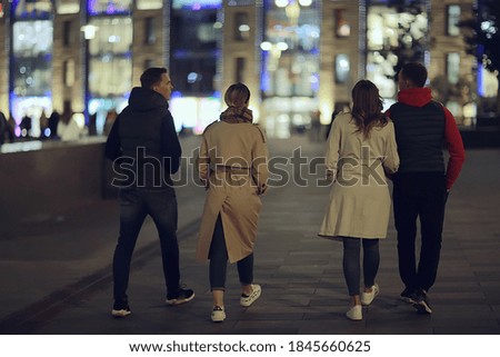 friends group autumn walk city street, night city, party in winter city