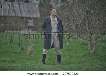 vintage man young village black and white, eastern europe style, retro coat and boots