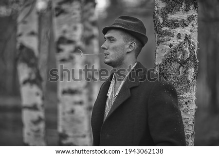 vintage man young village black and white, eastern europe style, retro coat and boots