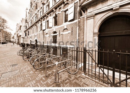 Typical Dutch brick houses in Holland. Street View with bikes parked in the historical center of Amsterdam in the Netherlands. Vintage Style Sepia photo