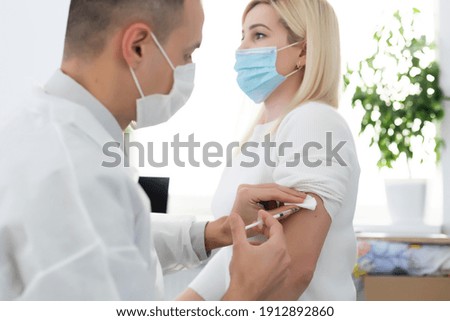 hand of medical staff injecting coronavirus covid-19 vaccine in vaccine syringe to arm muscle of caucasian man for coronavirus covid-19 immunization, coronavirus covid-19 vaccination,