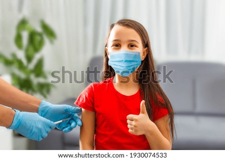 Little girl receiving vaccination in clinic, closeup. virus prevention