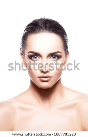 Young beautiful woman face portrait with healthy skin, bright eyes make-up, isolated over white background. Studio shot.
