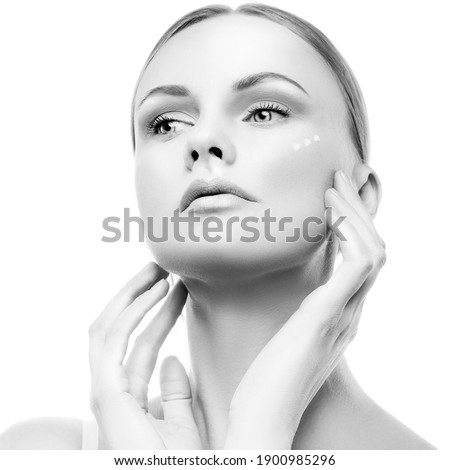 Beauty face of model woman apply cream. Healthy skin, no makeup. White backgrund. Isolated.  Skincare facial treatment female health concept. Monochrome
